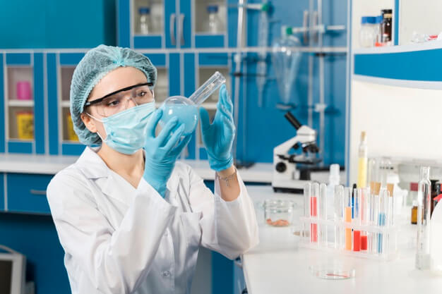 Woman pipetting biomedical laboratory.